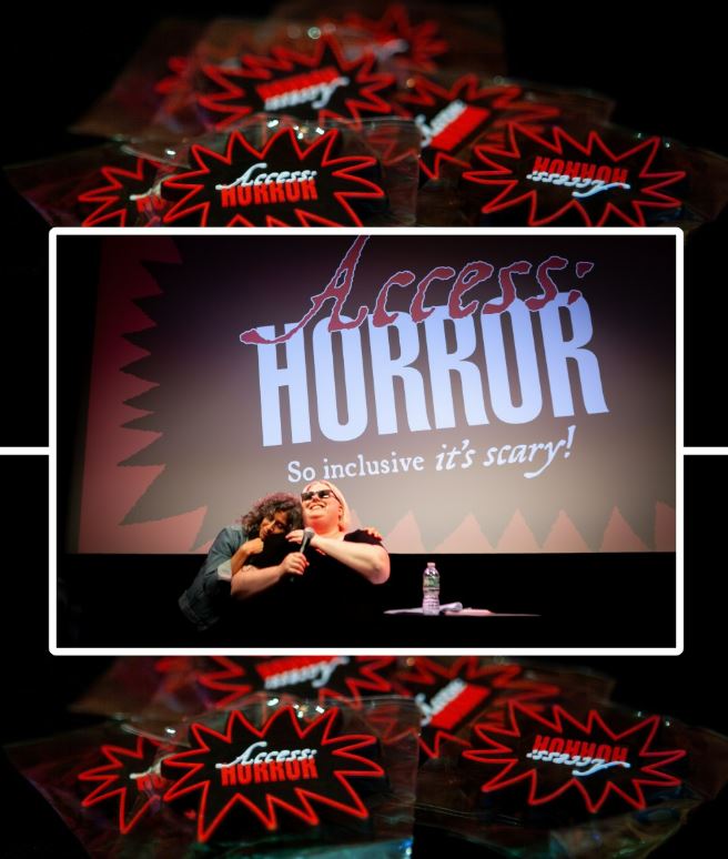 ID: A center image of Ariel Baska grinning in front of the Access:Horror logo as it’s projected on the film screen behind them. A woman with curly gray hair is hugging their shoulders from behind. The image is outlined in a white border that intersects with the above and below background images showing a pile of Access:Horror spiky logo magnets in red, black, and white.